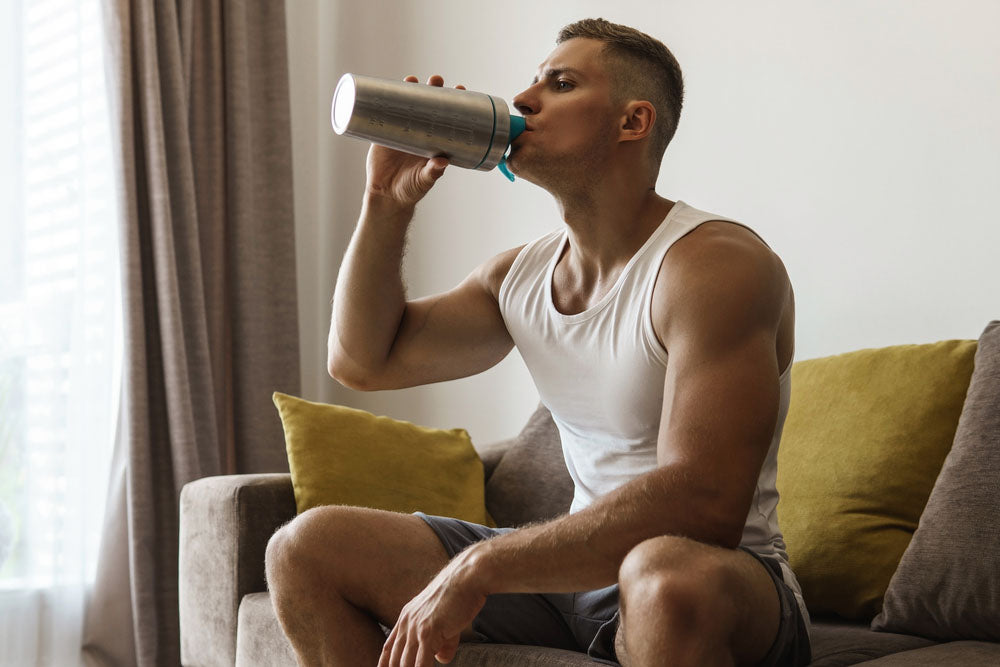A man drinking a pre-workout shake.